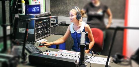 Two young women at a radio mixing desk at SYN Media Two young women at a radio mixing desk at SYN Media