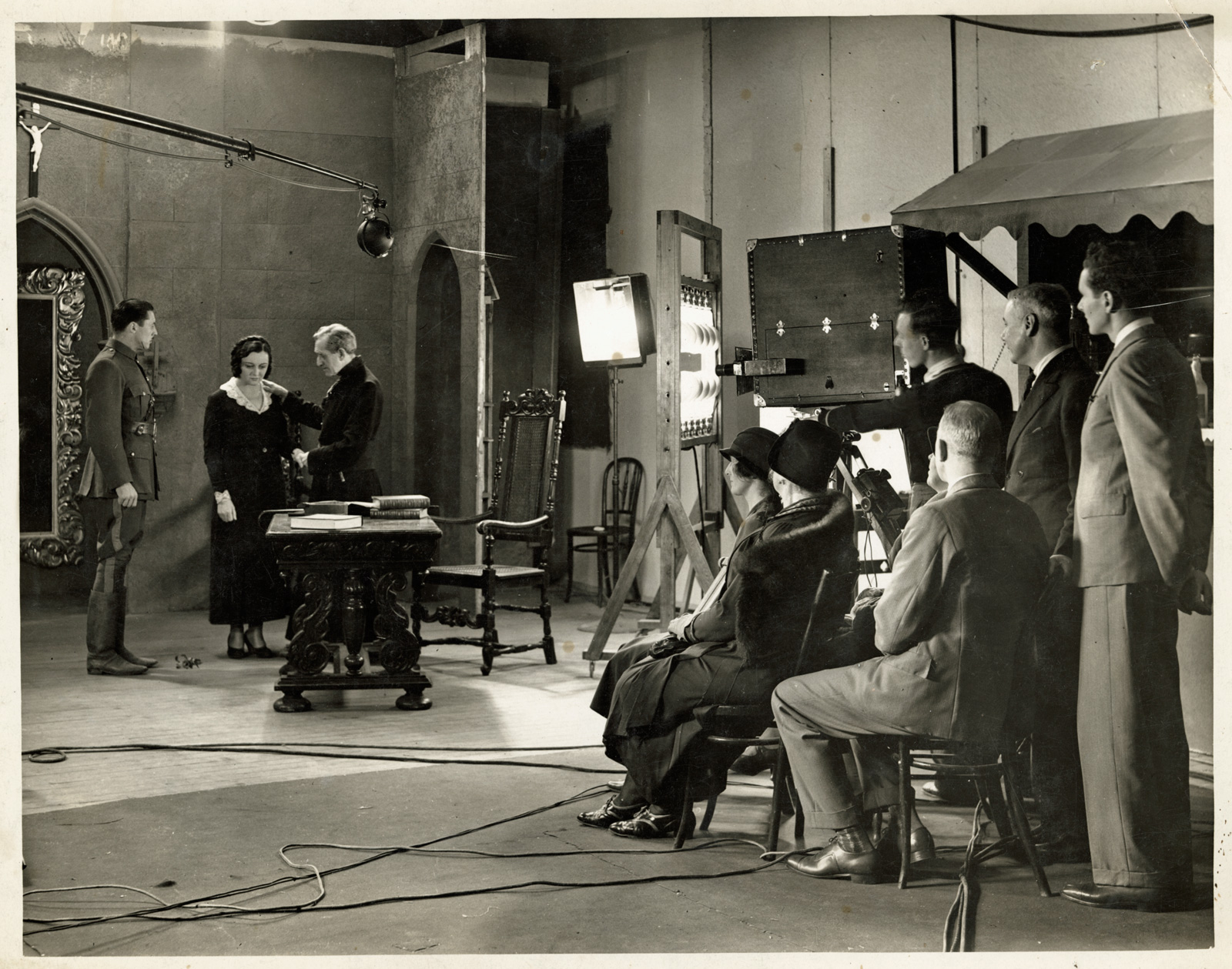 Paulette McDonagh directing Two Minutes Silence A film studio where you can see the director, crew and actors filming a scene.
